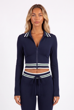 Navy striped-trim zip crop top and flared trouser set — collar, zip and waistband detail