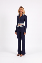 Navy striped-trim zip crop top and flared trouser set — three-quarter