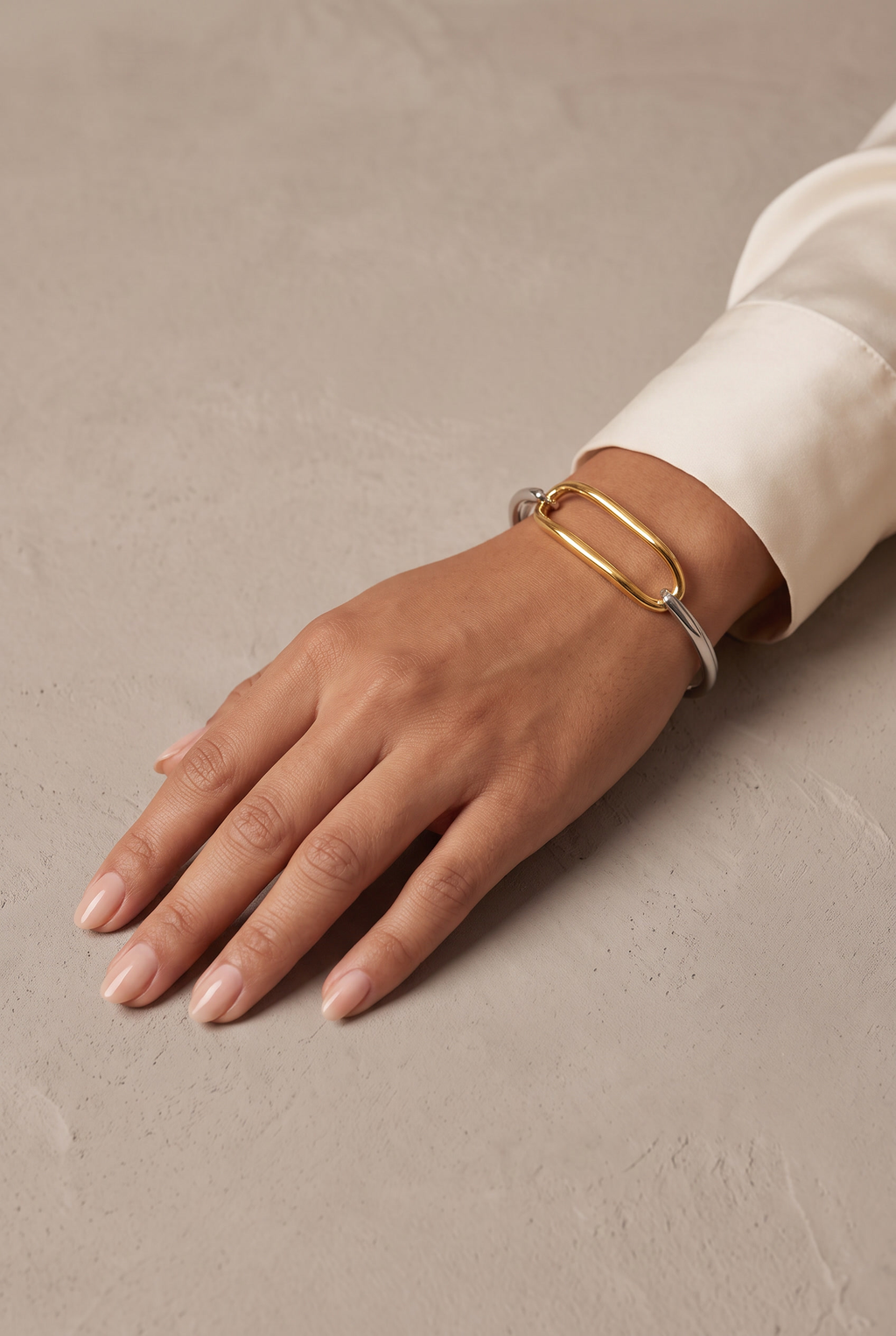 Two-tone oval link bracelet worn on the wrist