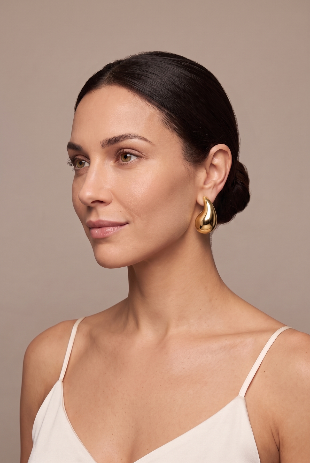Chunky teardrop drop stud in gold worn on the ear