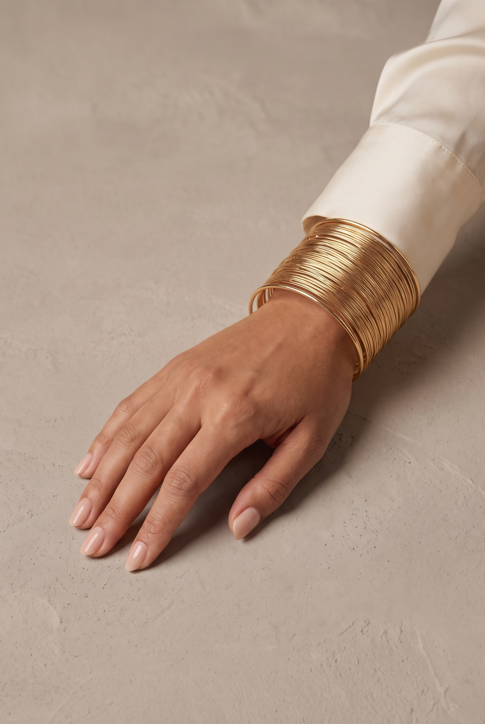 Wide layered wire cuff in gold worn on the wrist