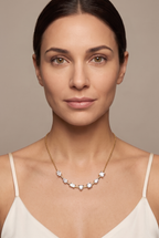 Seven-stone mixed-cut bar necklace worn at the collarbone